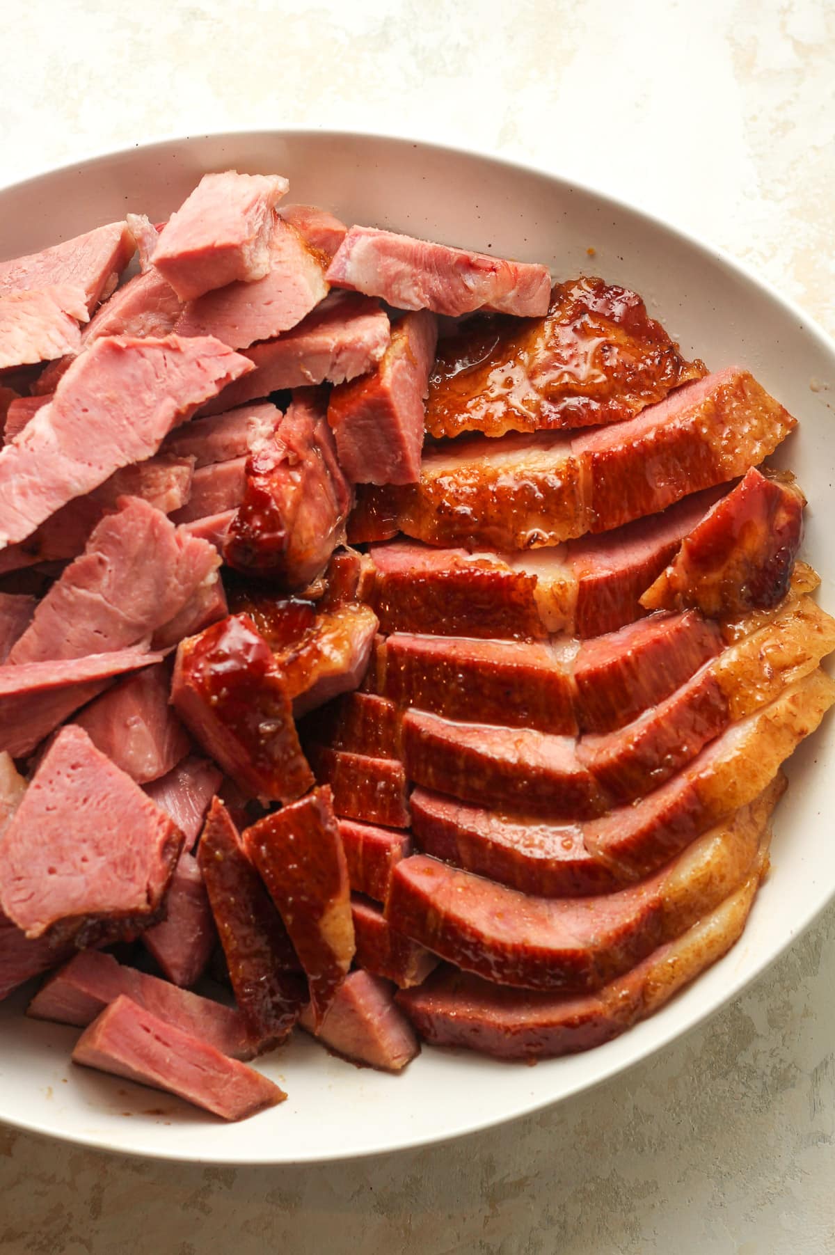 A platter of thick sliced ham with maple glaze.