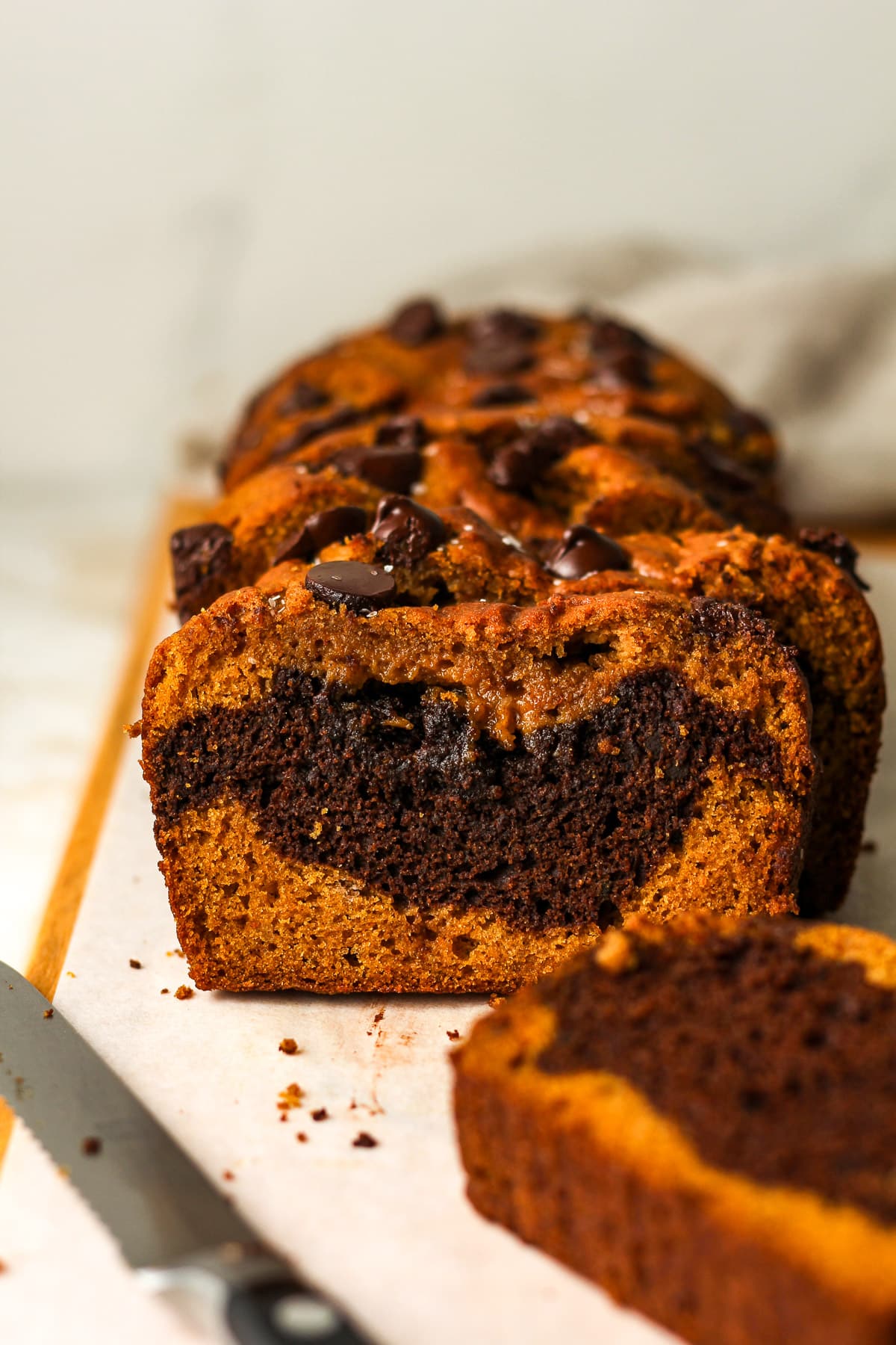 Side view of sliced pumpkin bread with chocolate swirl.