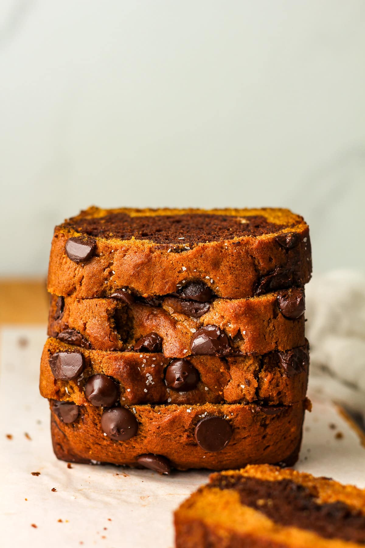 Side view of four slices of stacked pumpkin chocolate bread.