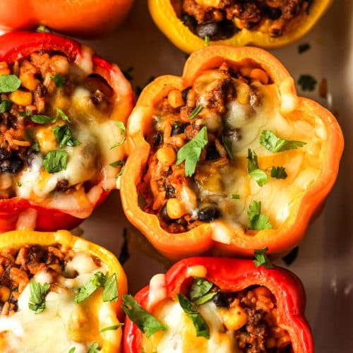 Overhead view of six stuffed bell peppers.