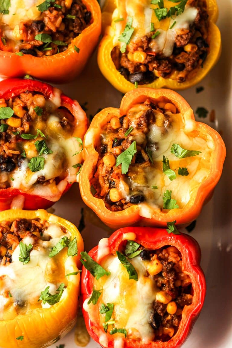 Overhead view of six stuffed bell peppers.