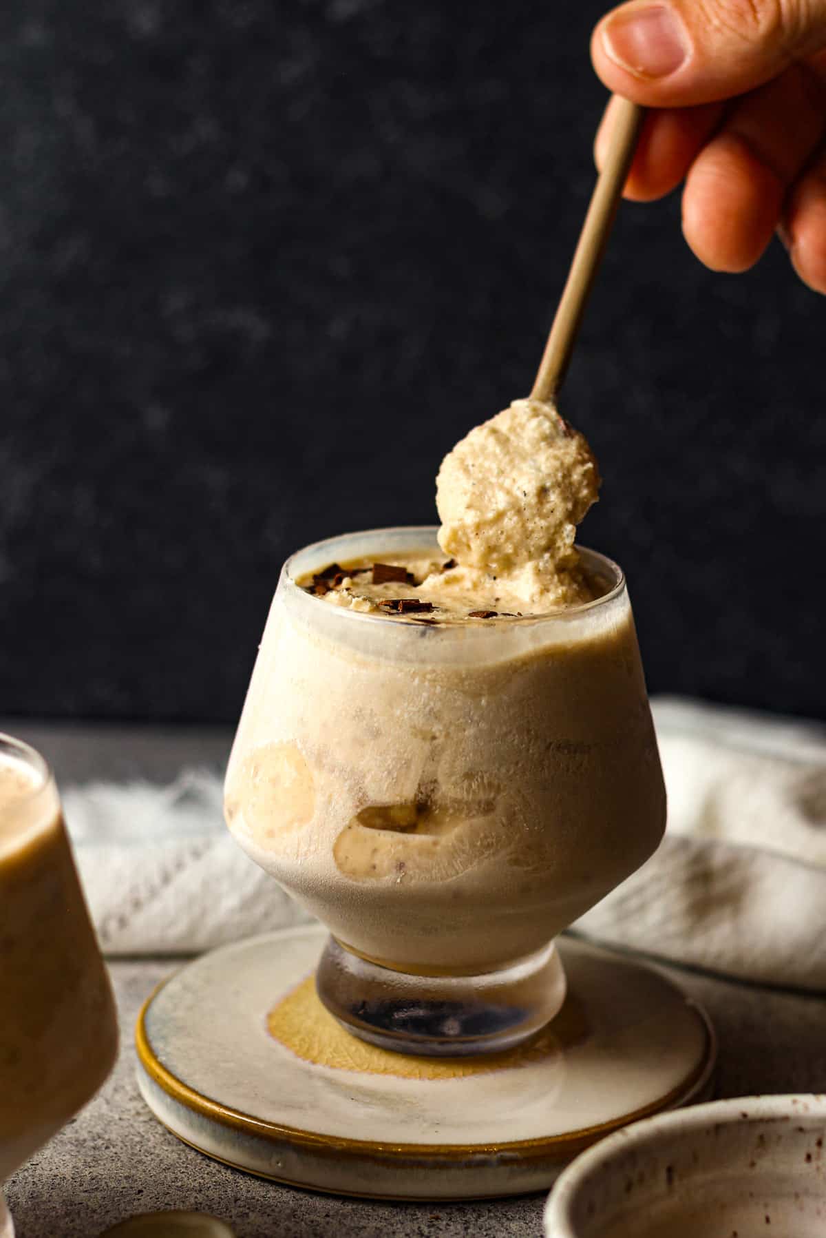 A hand lifting a spoonful of frozen cocktail.