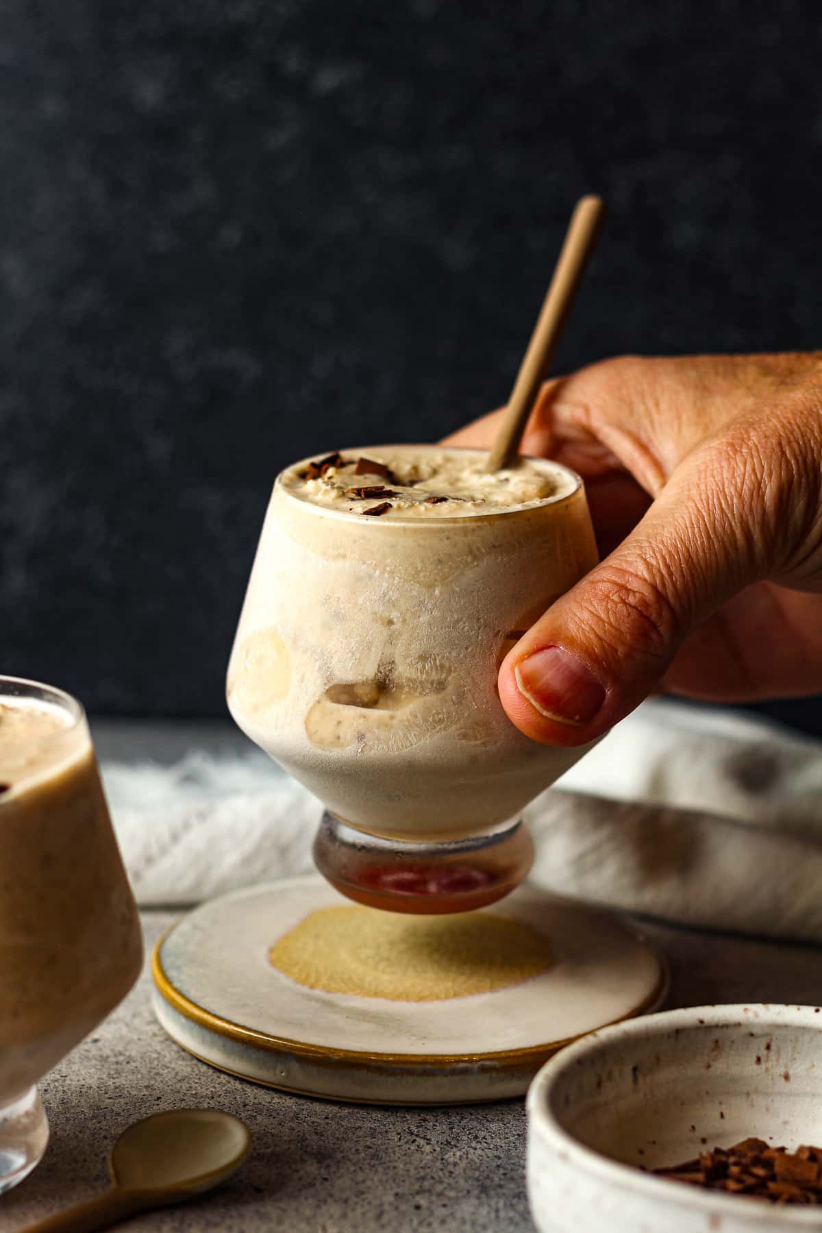 A hand lifting a frozen kahlua cocktail.