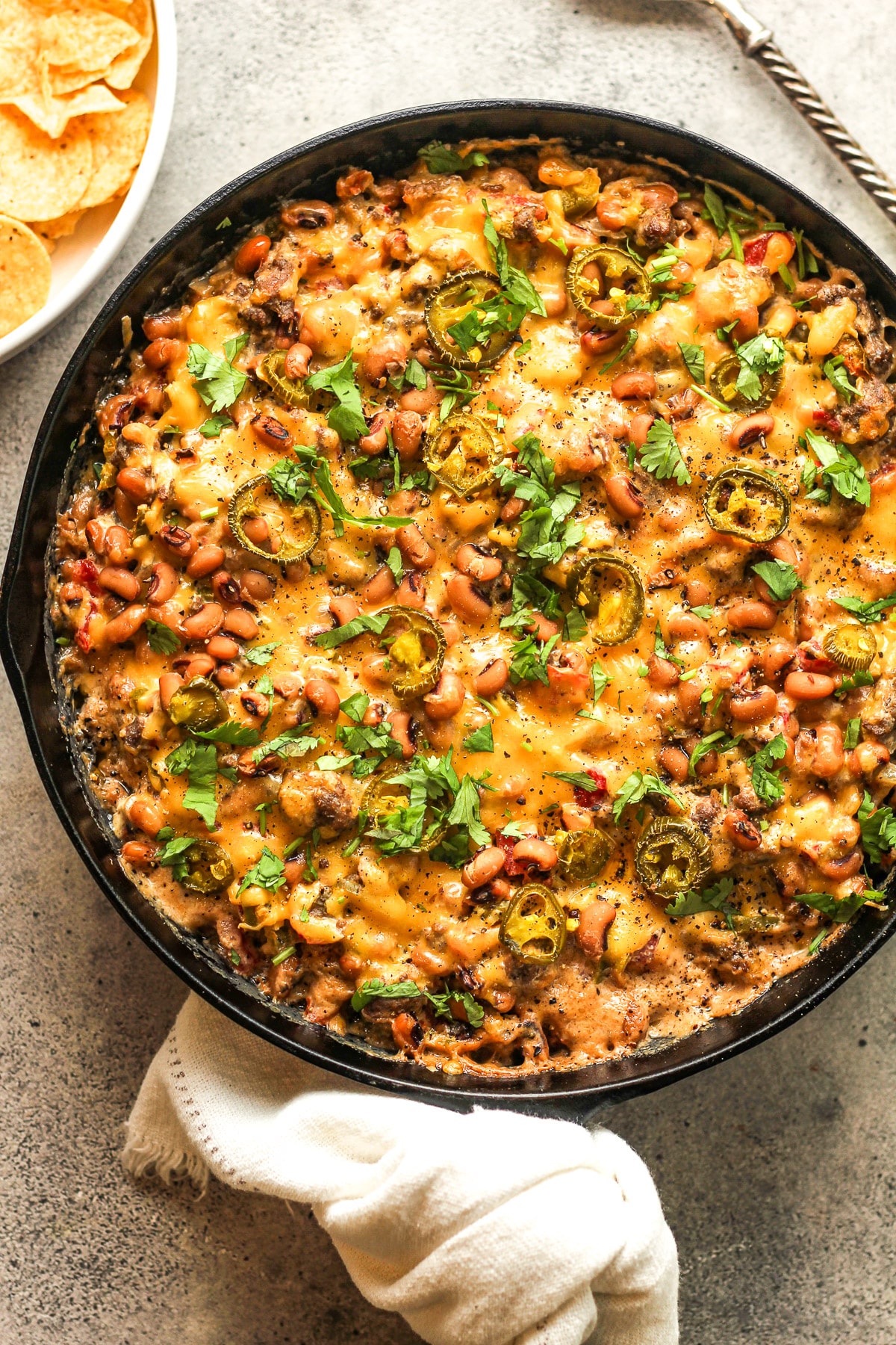 A cast iron skillet with black eyed pea dip.