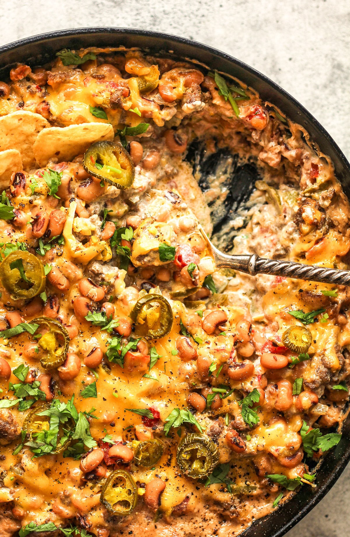 Closeup on the creamy dip inside the skillet.