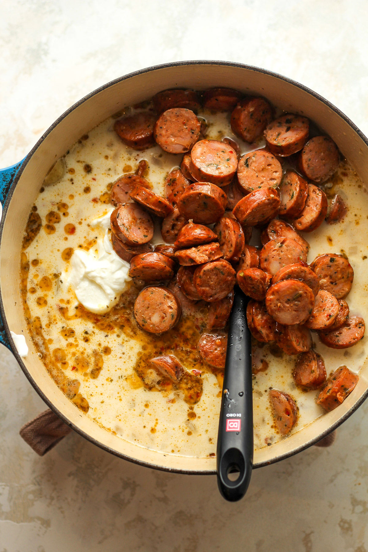 The pot of soup after adding in the sausage and dairy.