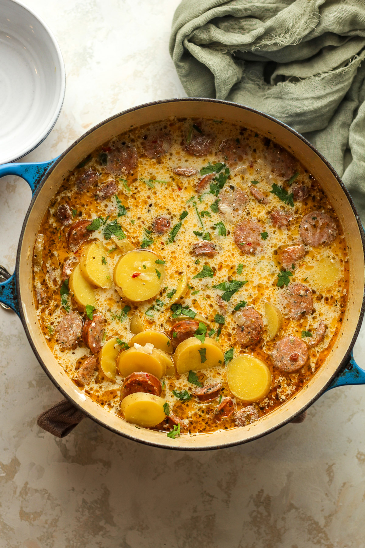 Overhead view of a pot of kielbasa soup with yellow potatoes.