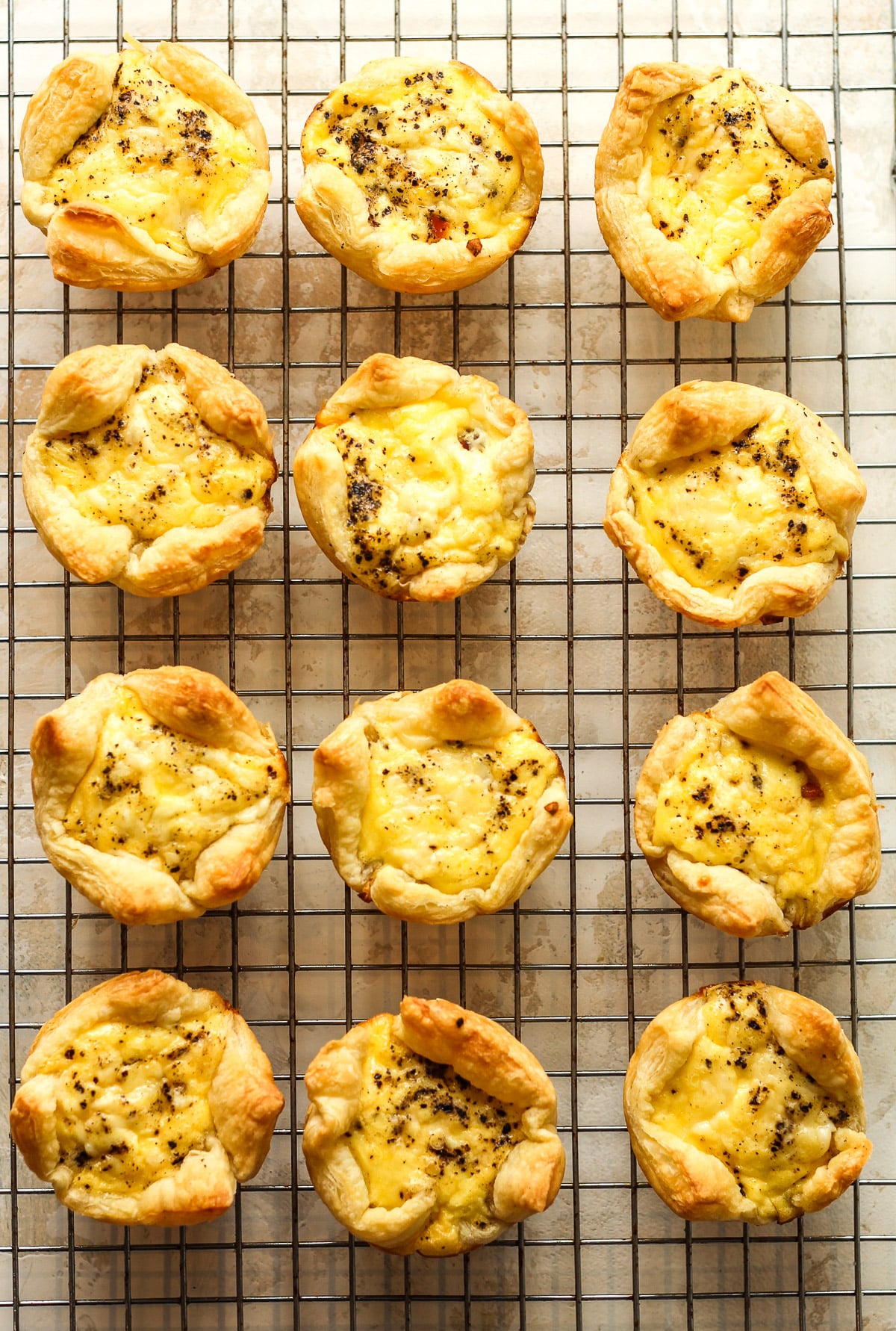 A wire rack of the mini quiche cooling off.