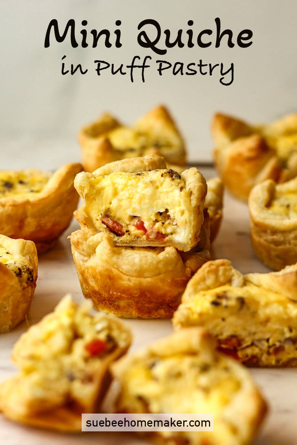 Two stacked mini quiche in puff pastry.