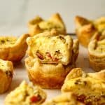 Side view of stacked mini quiche with bacon.