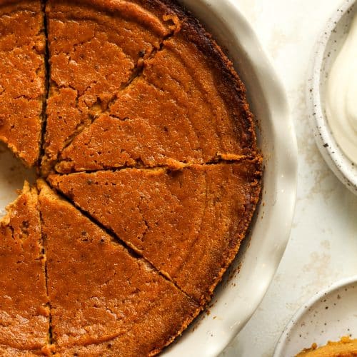 Closeup on a portion of a sliced pumpkin pie.