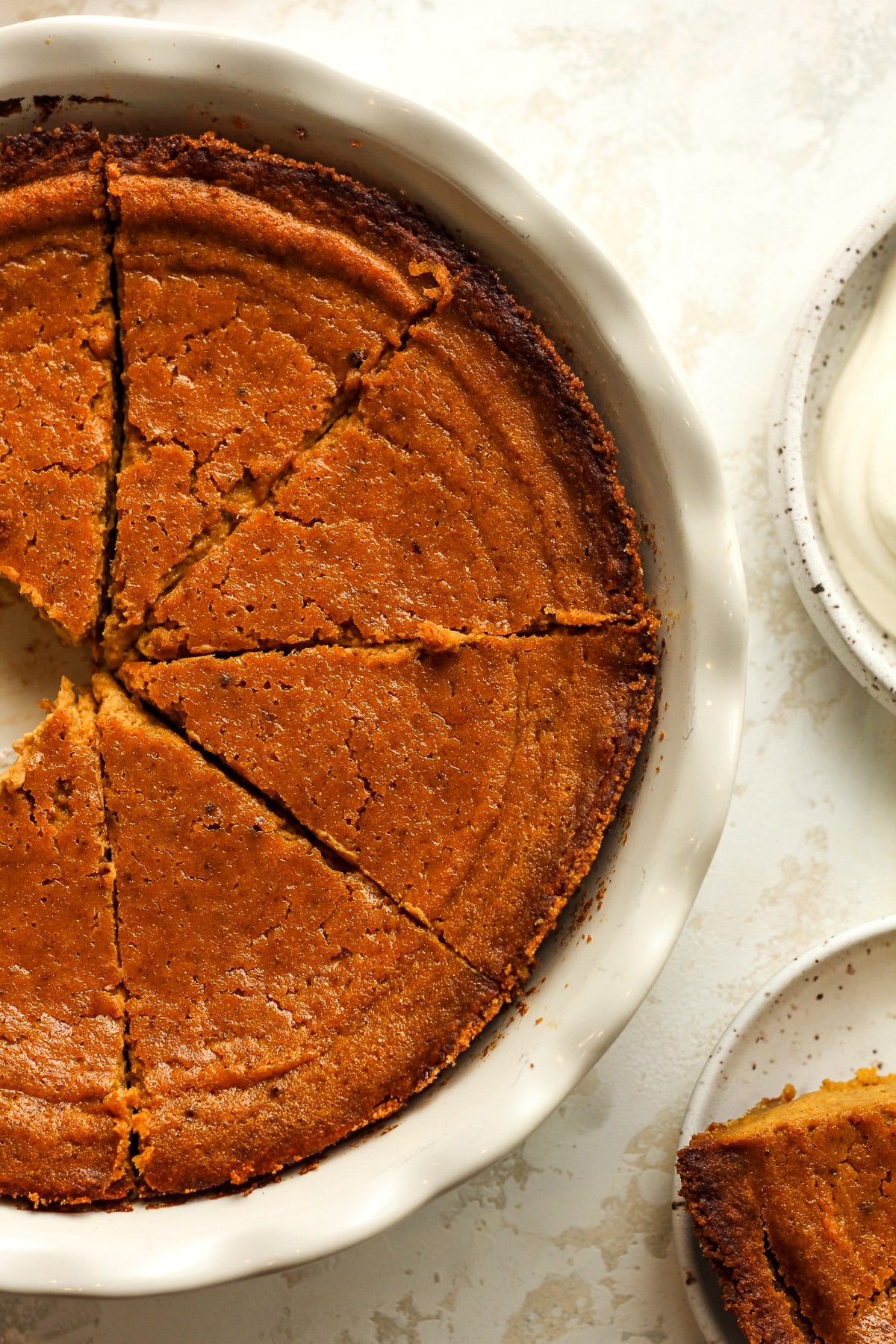 Closeup on a portion of a sliced pumpkin pie.