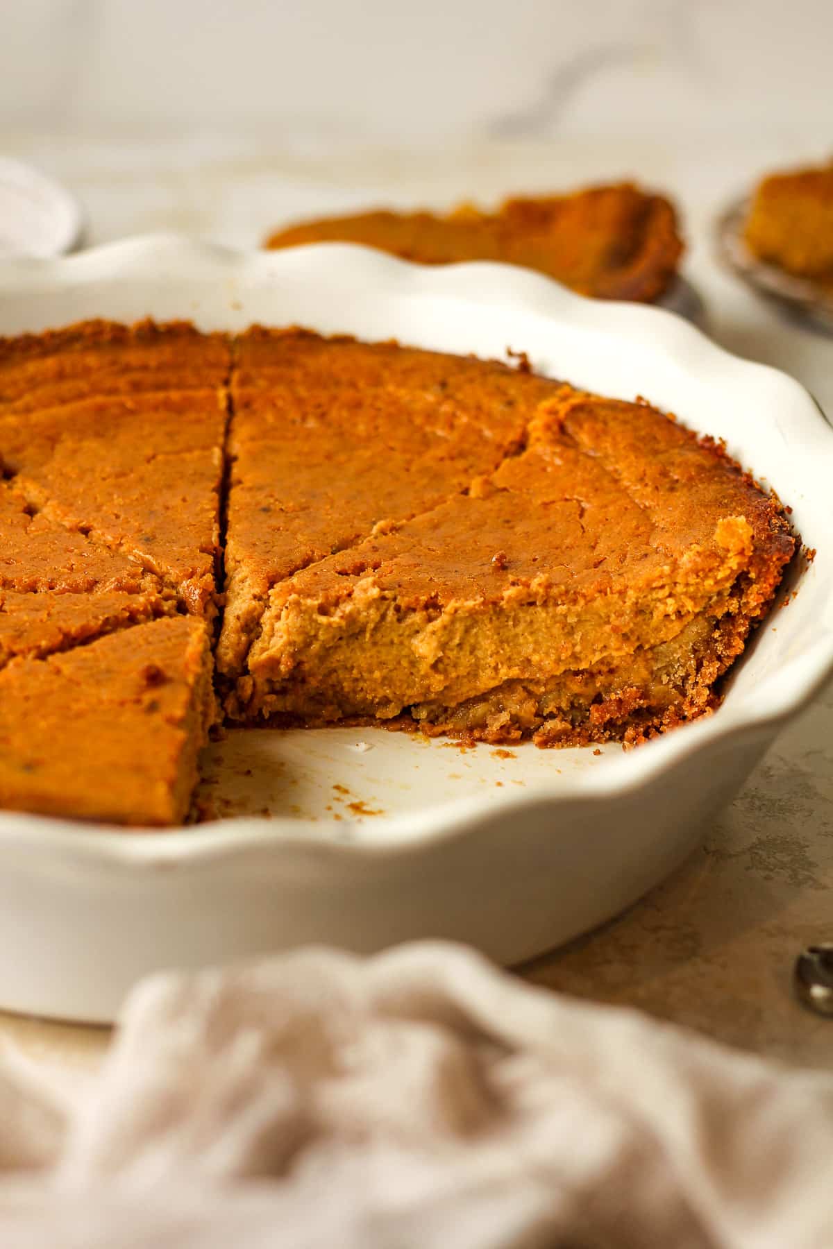 Side view of a sliced pumpkin pie.