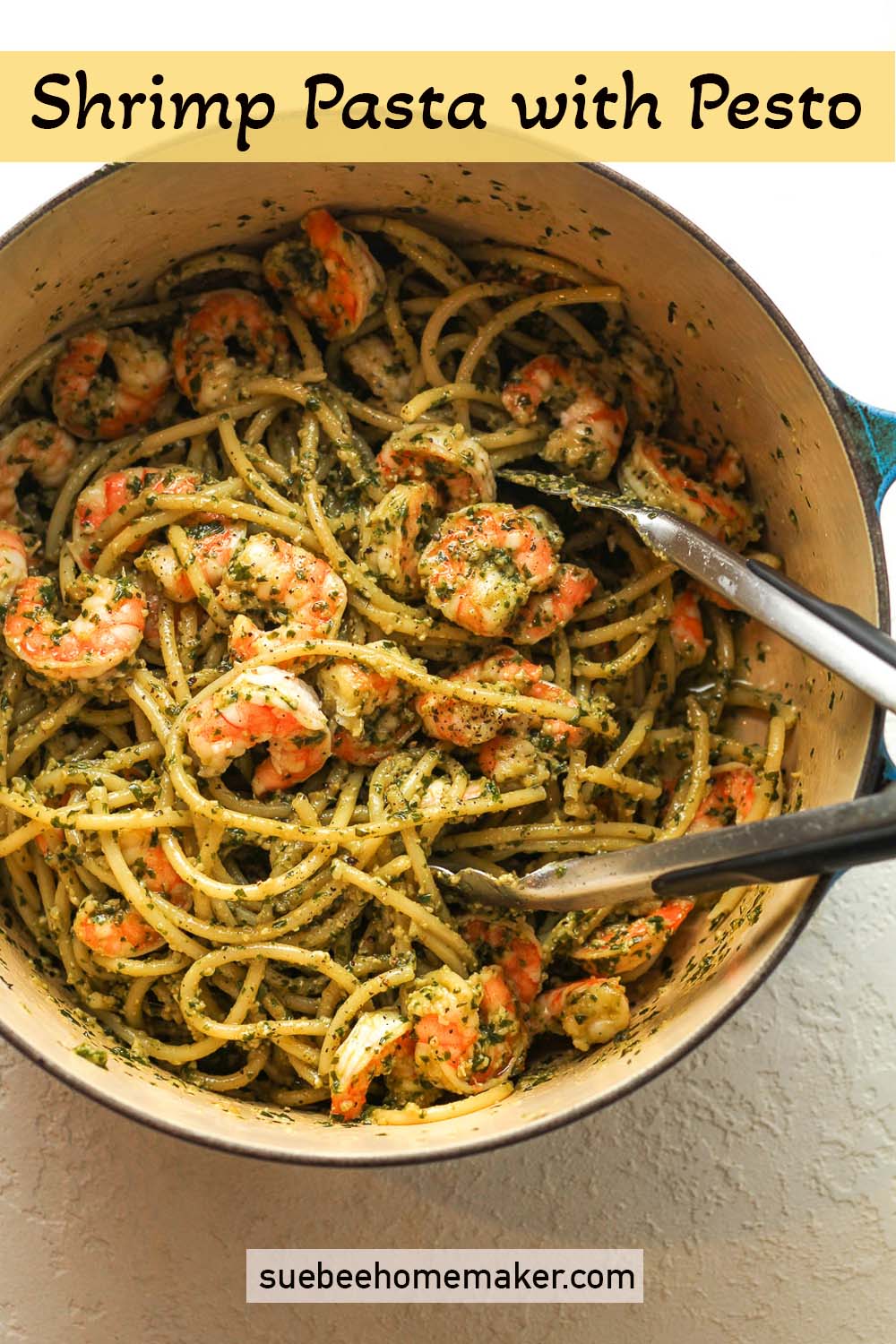 A pot of shrimp pasta with pesto.