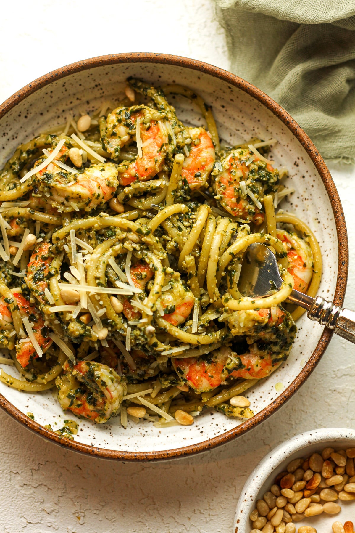 A bowl of the shrimp pasta with pesto sauce.