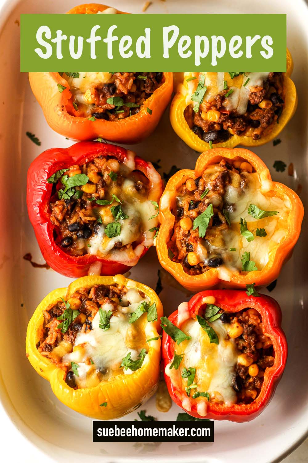 Overhead view of six stuffed peppers in a casserole dish.