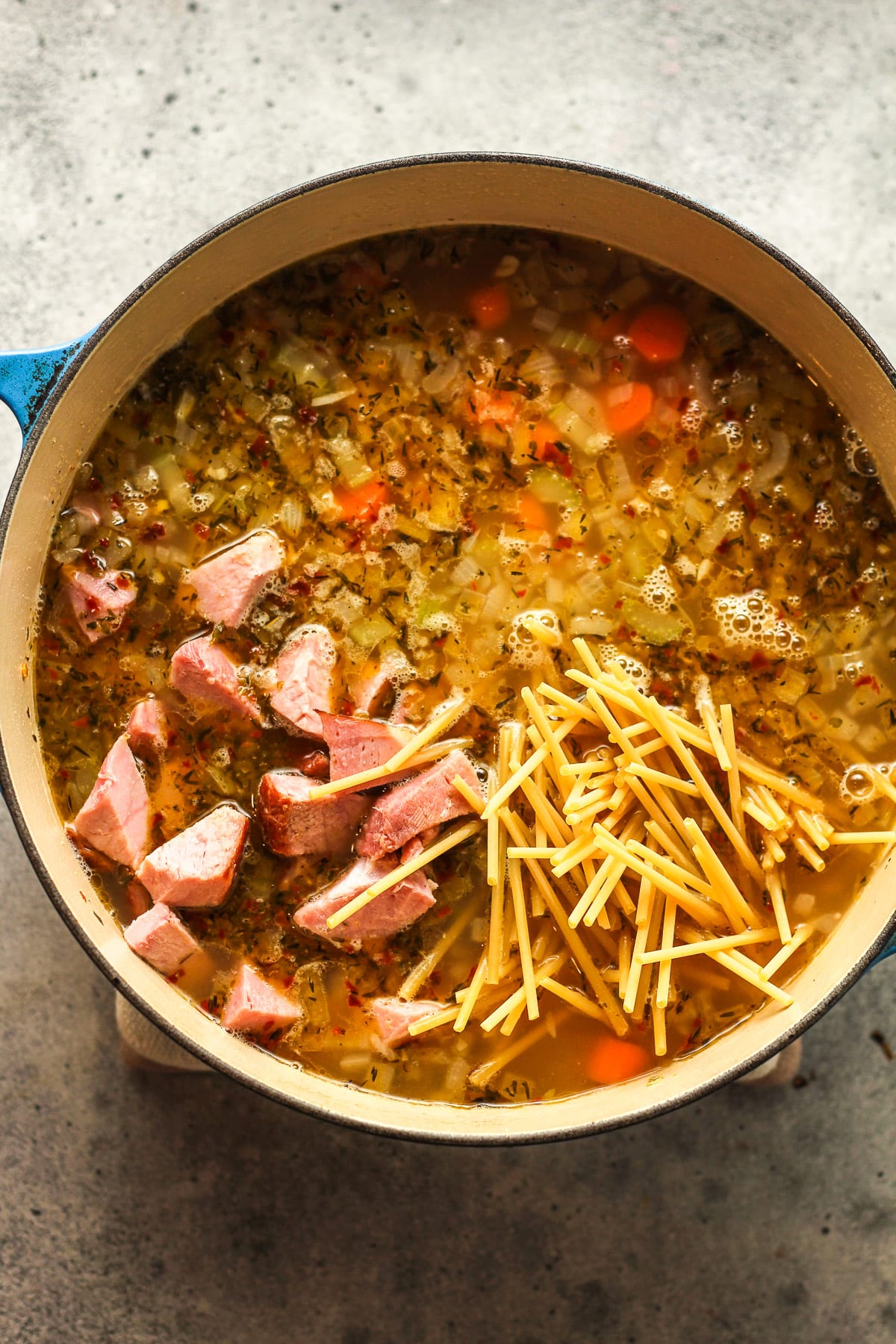 A pot of the soup after adding in the ham and noodles.