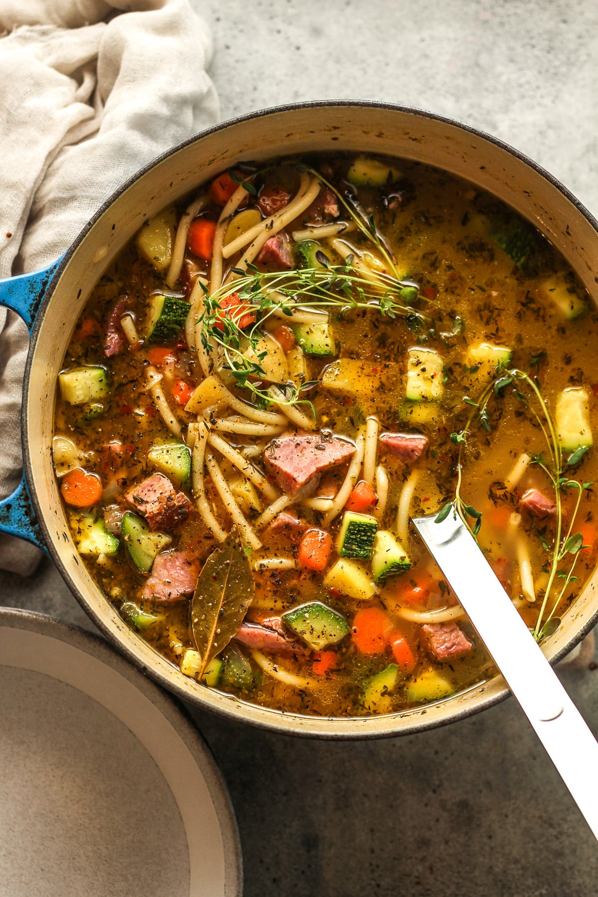 A pot of ham and veggie soup.