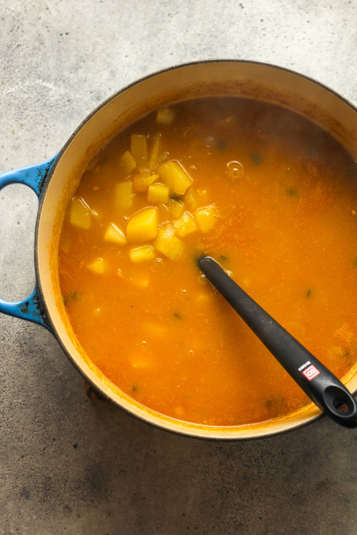 A stockpot of the chowder after cooking the potatoes.