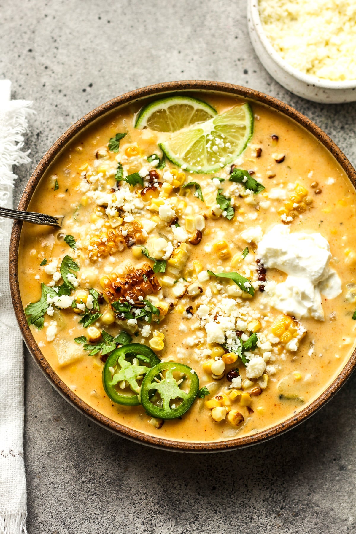 A bowl of corn chowder with Mexican street corn.