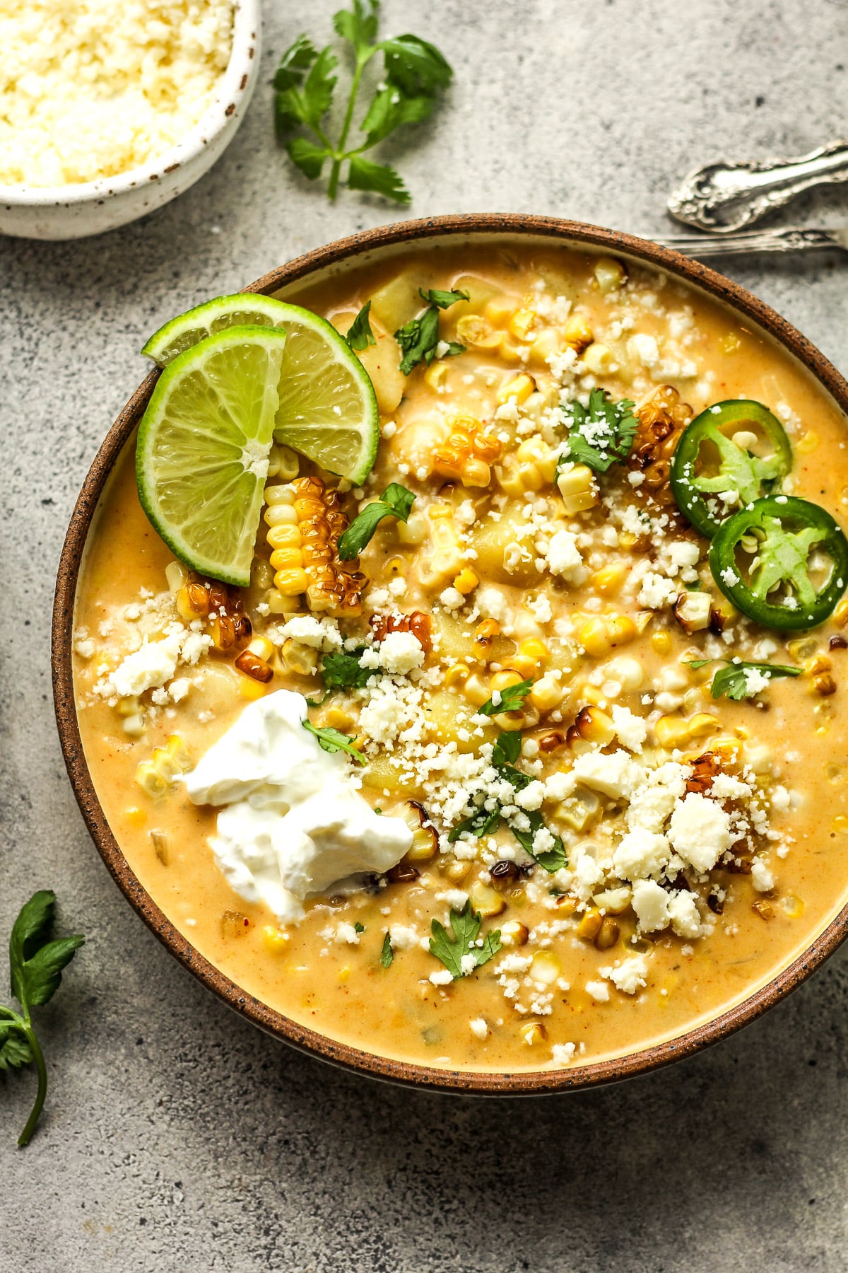 A bowl of Mexican Street Corn chowder with sliced jalapenos.