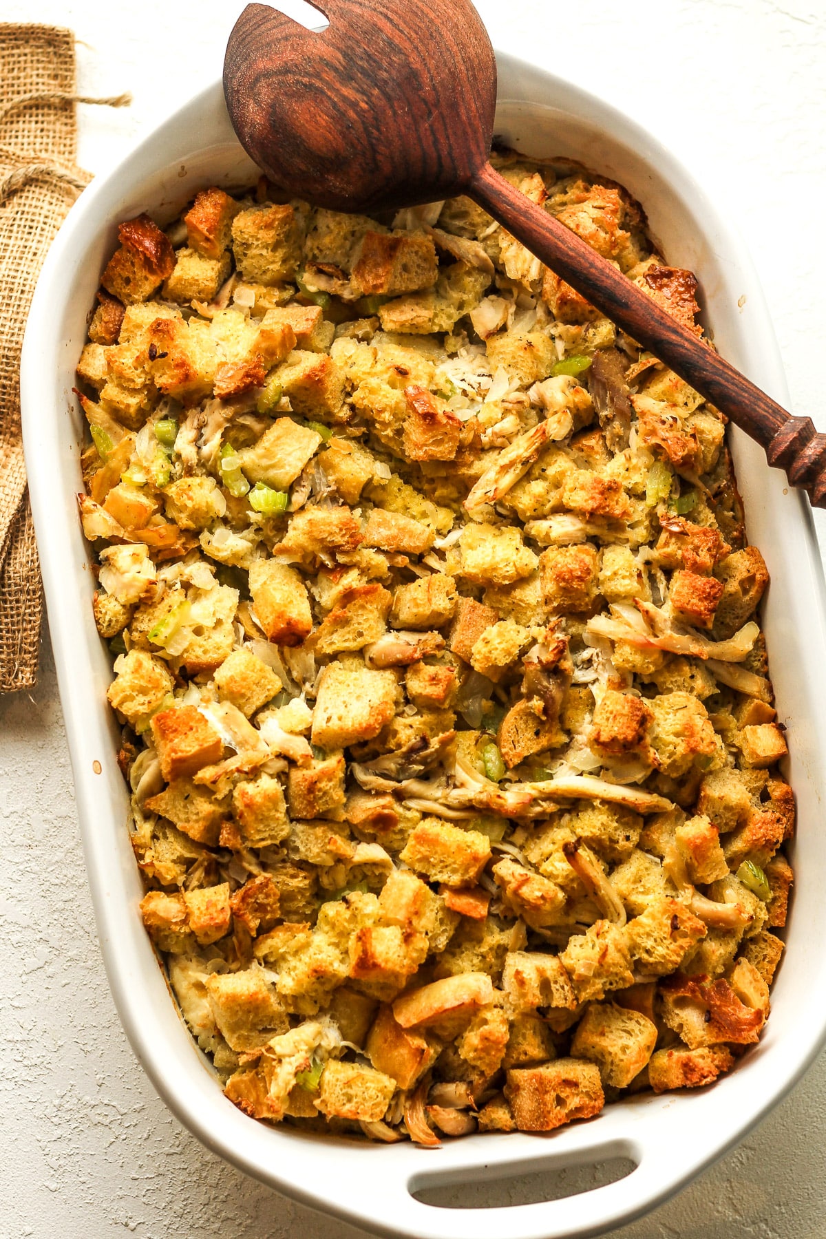 A large casserole of baked Thanksgiving dressing with chicken.