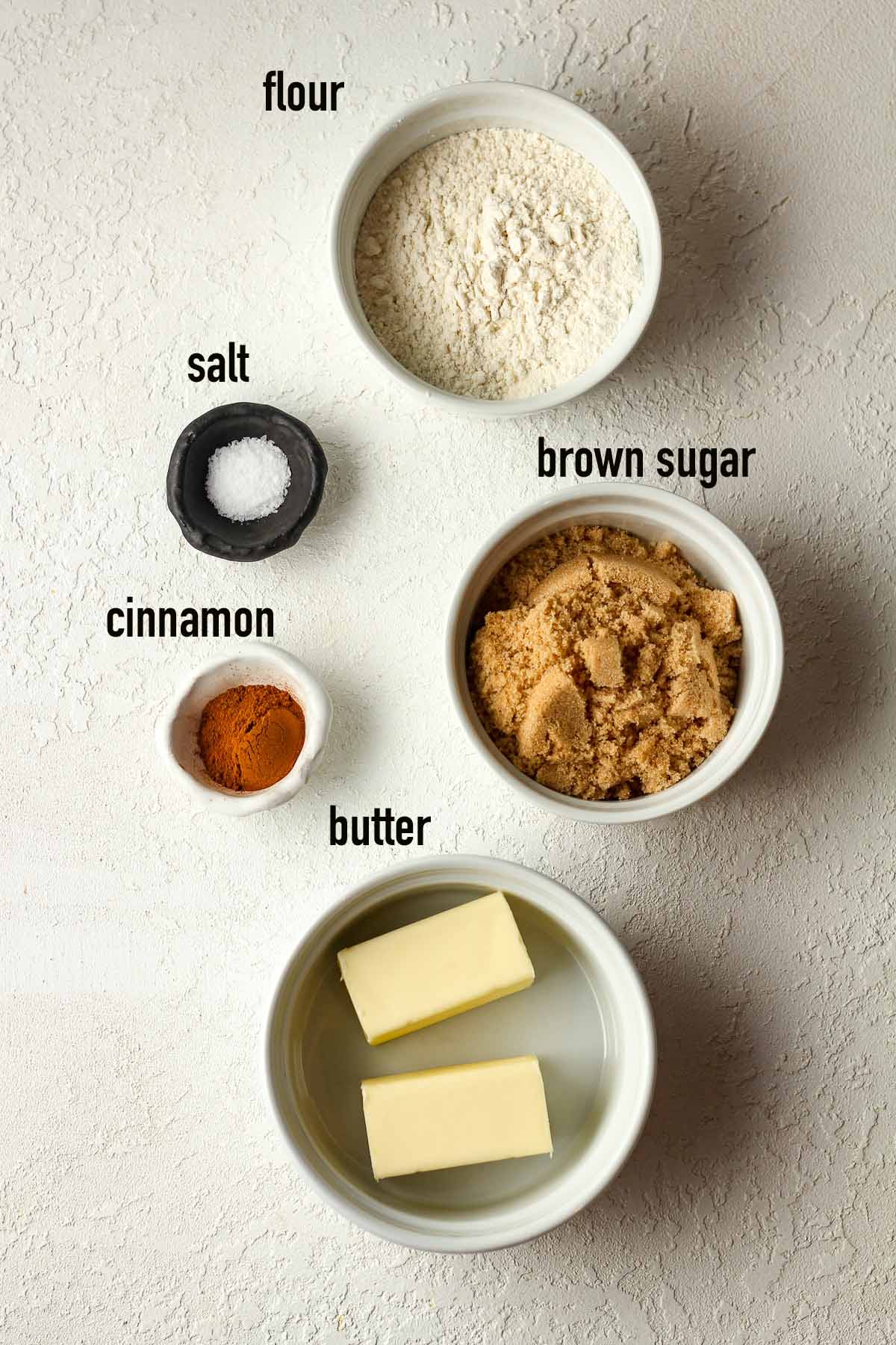 The topping ingredients in bowls with labels.