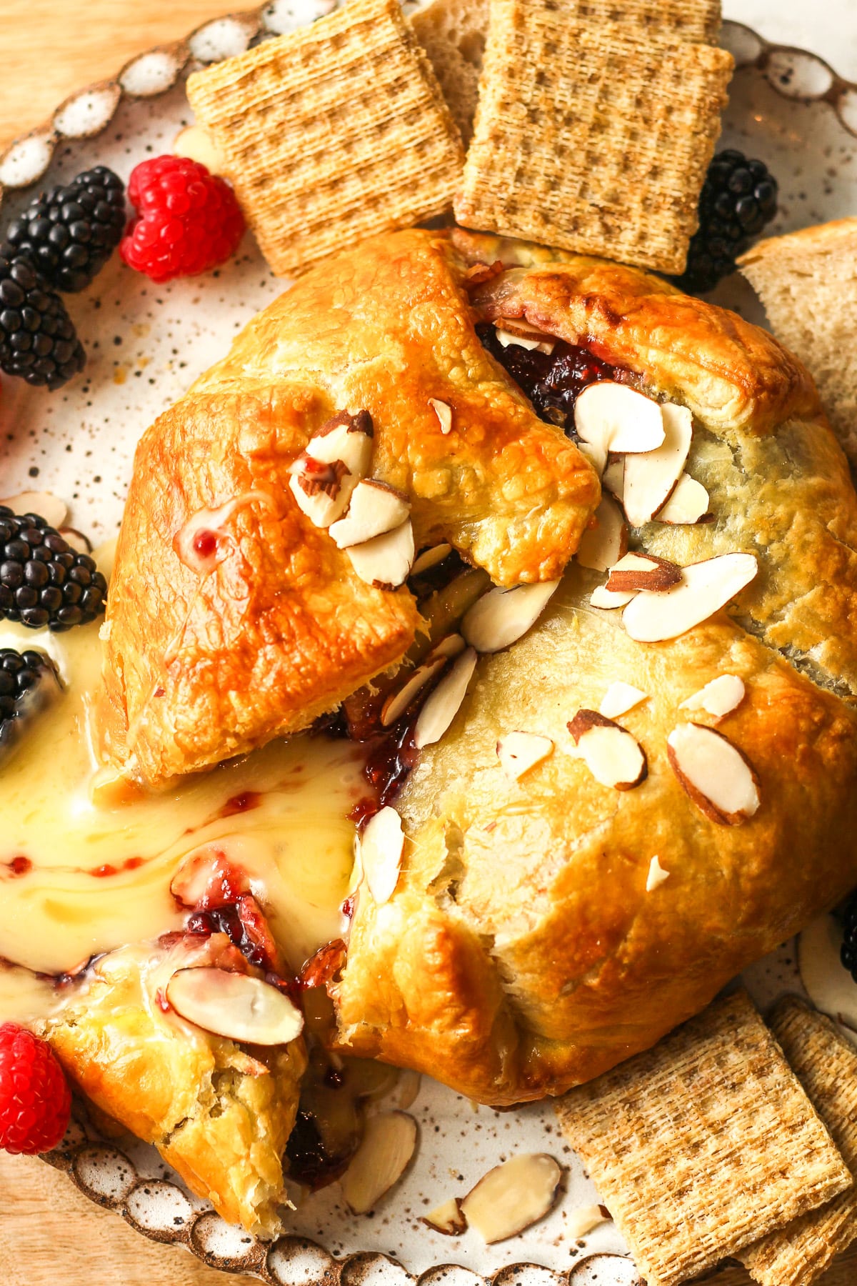 Overhead view of the baked brie and jam in puff pastry on a plate.