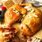 Side view of brie and jam in puff pastry after baking and cutting into it.