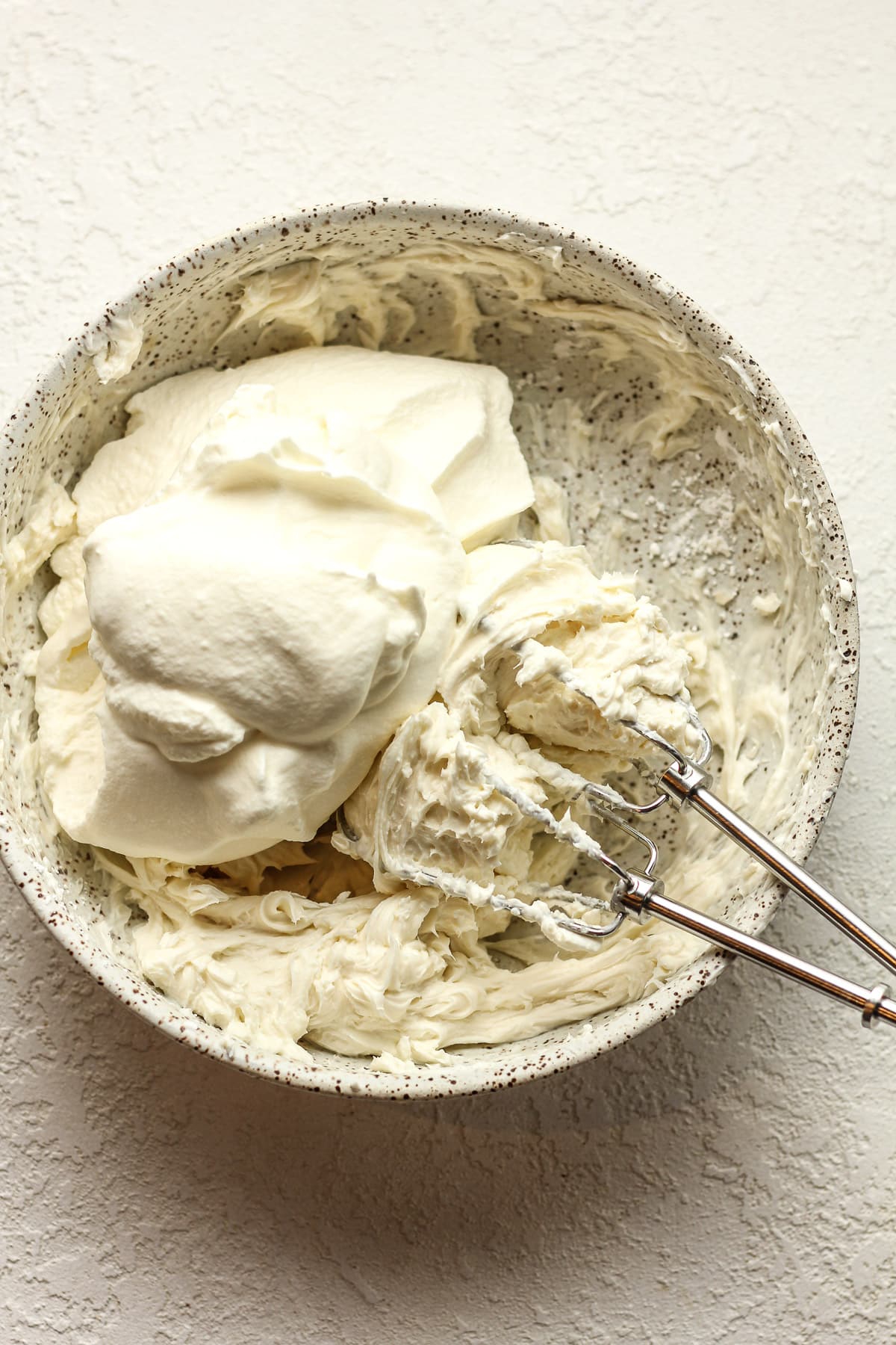 A bowl of the cream cheese mixture plus the whipped cream.