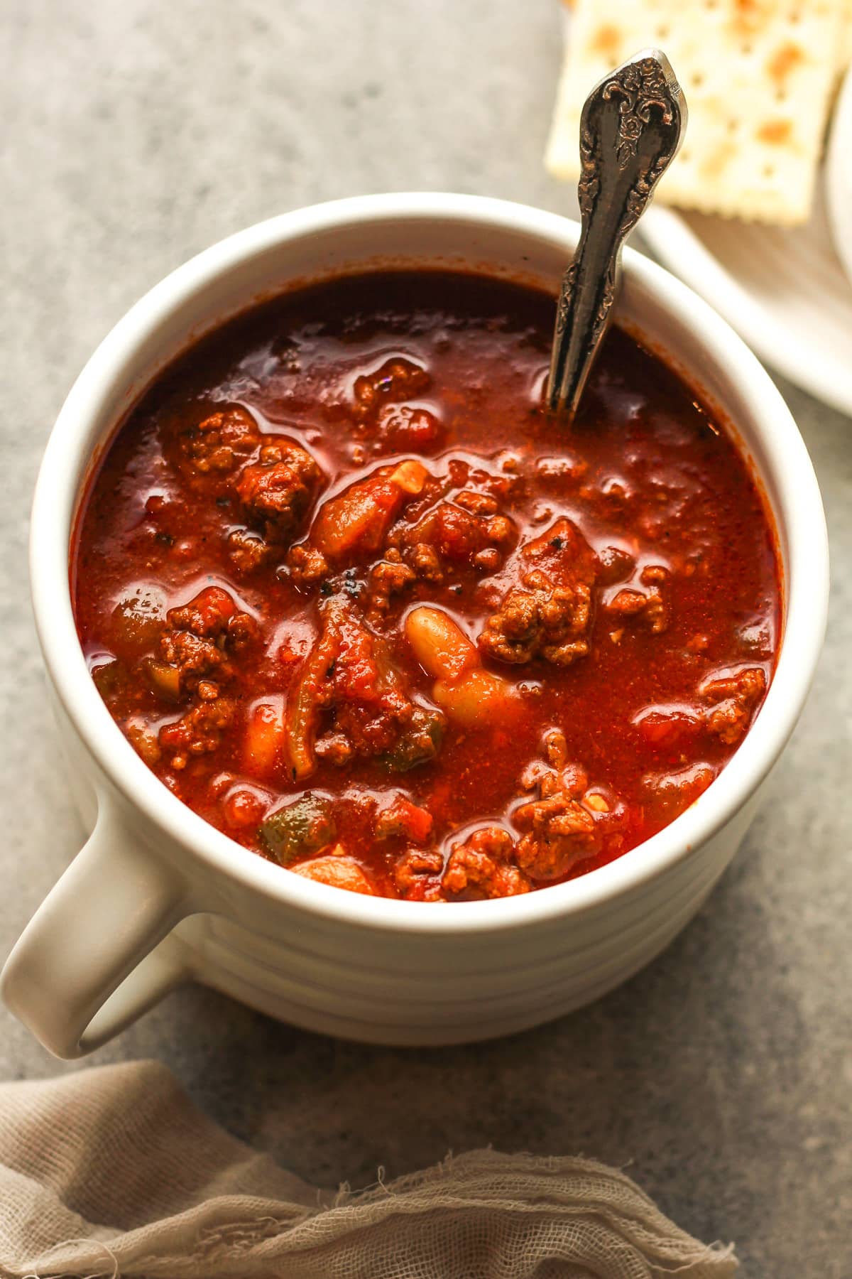 A mug of beef chili and beans.