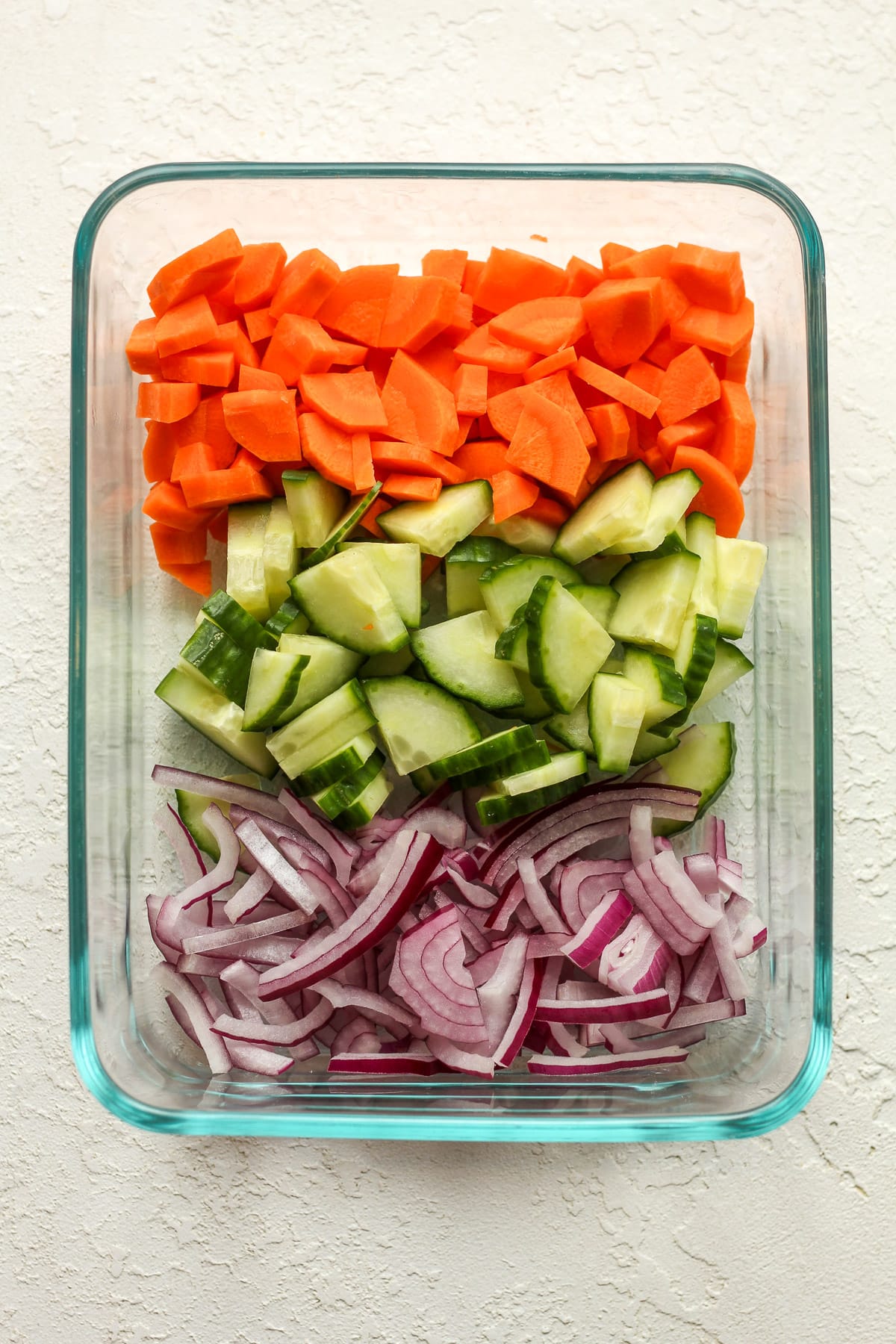 A rectangular dish of chopped veggies.