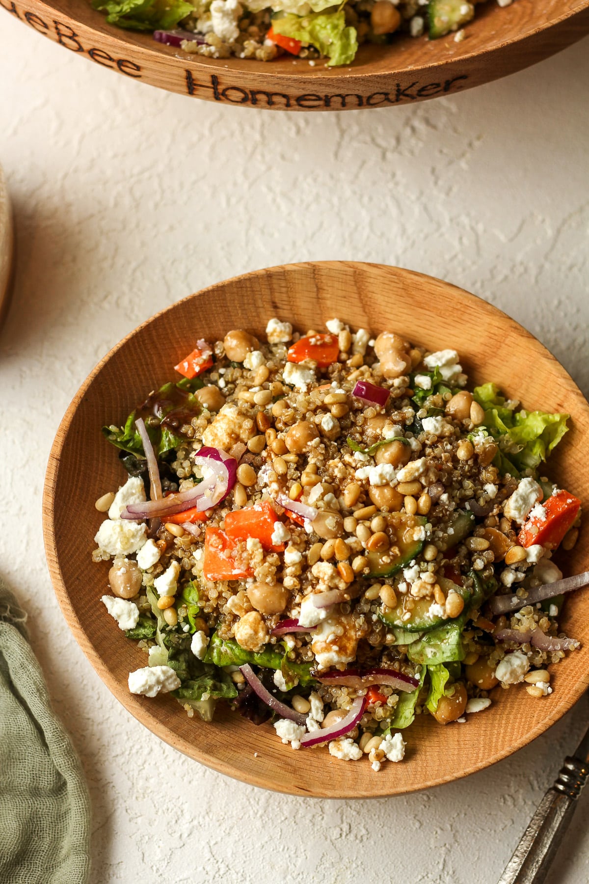 Overhead view of a serving bowl of quinoa salad with goat cheese.