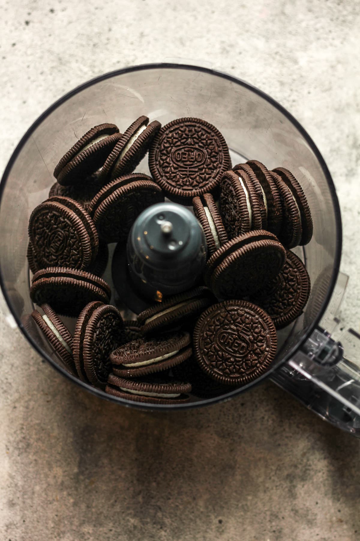 A food processor with the Oreo cookies inside it.