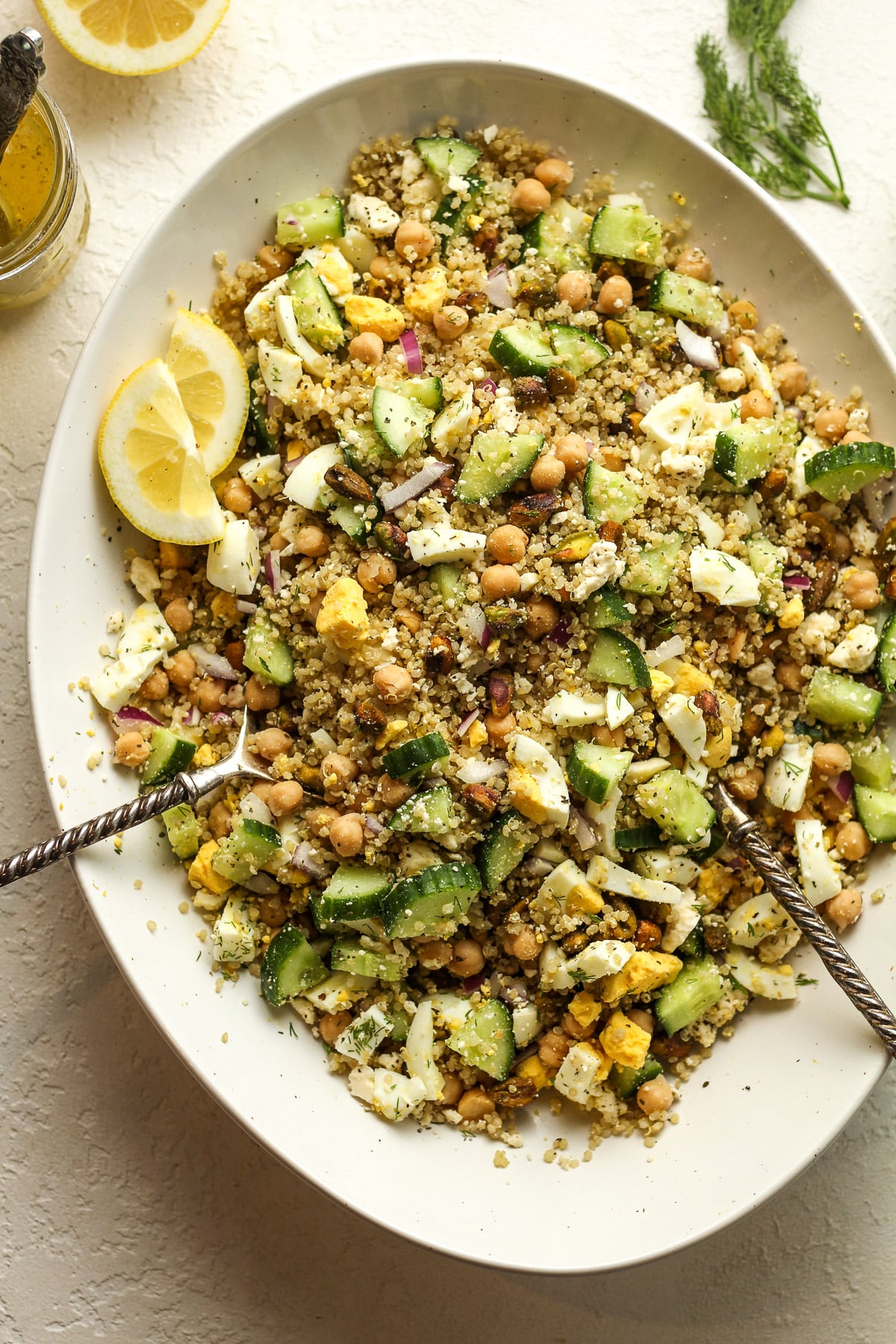 An oblong white dish with high protein quinoa salad mixed together.