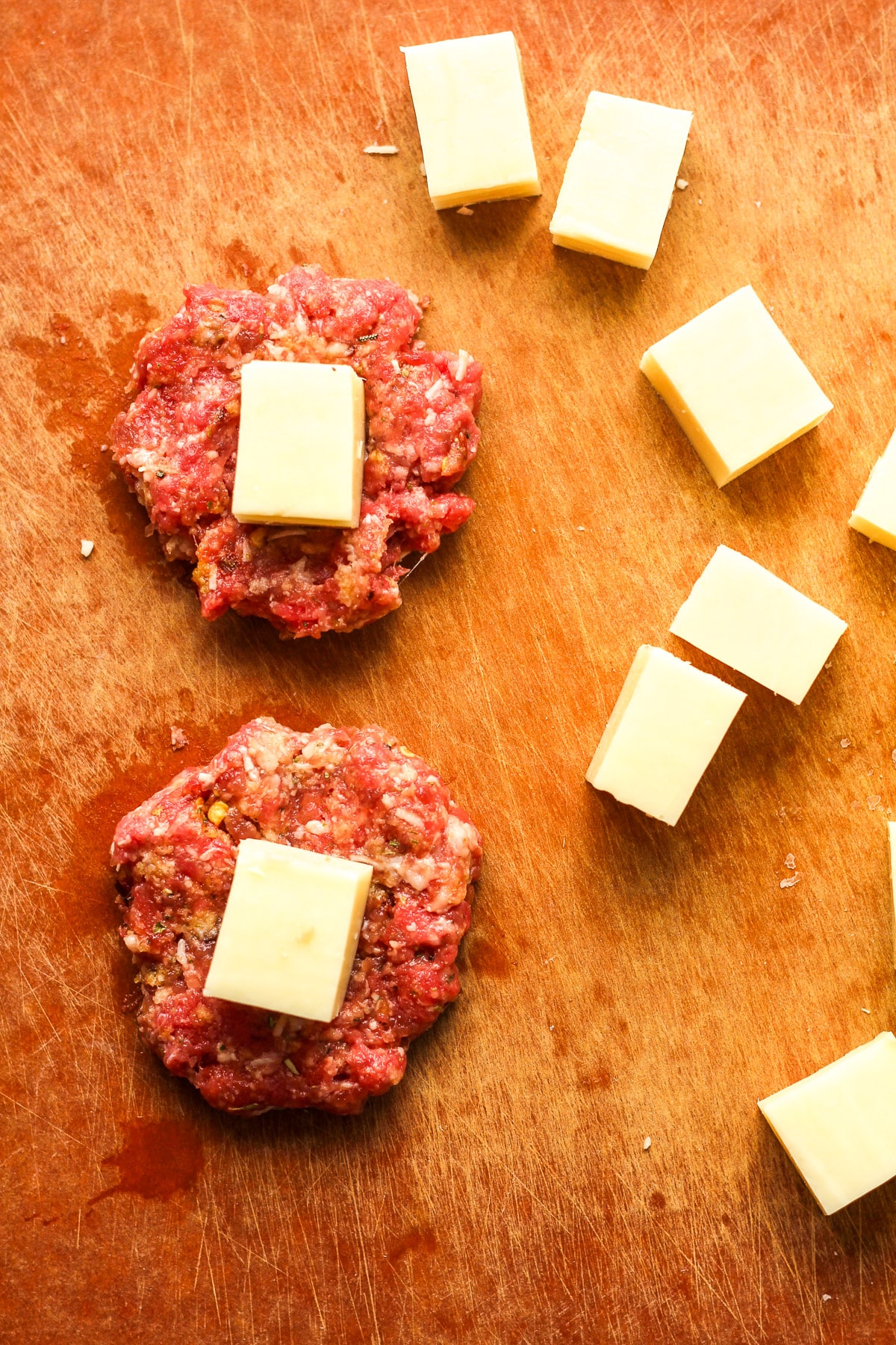 A board showing how the meatballs are stuffed with cheese.