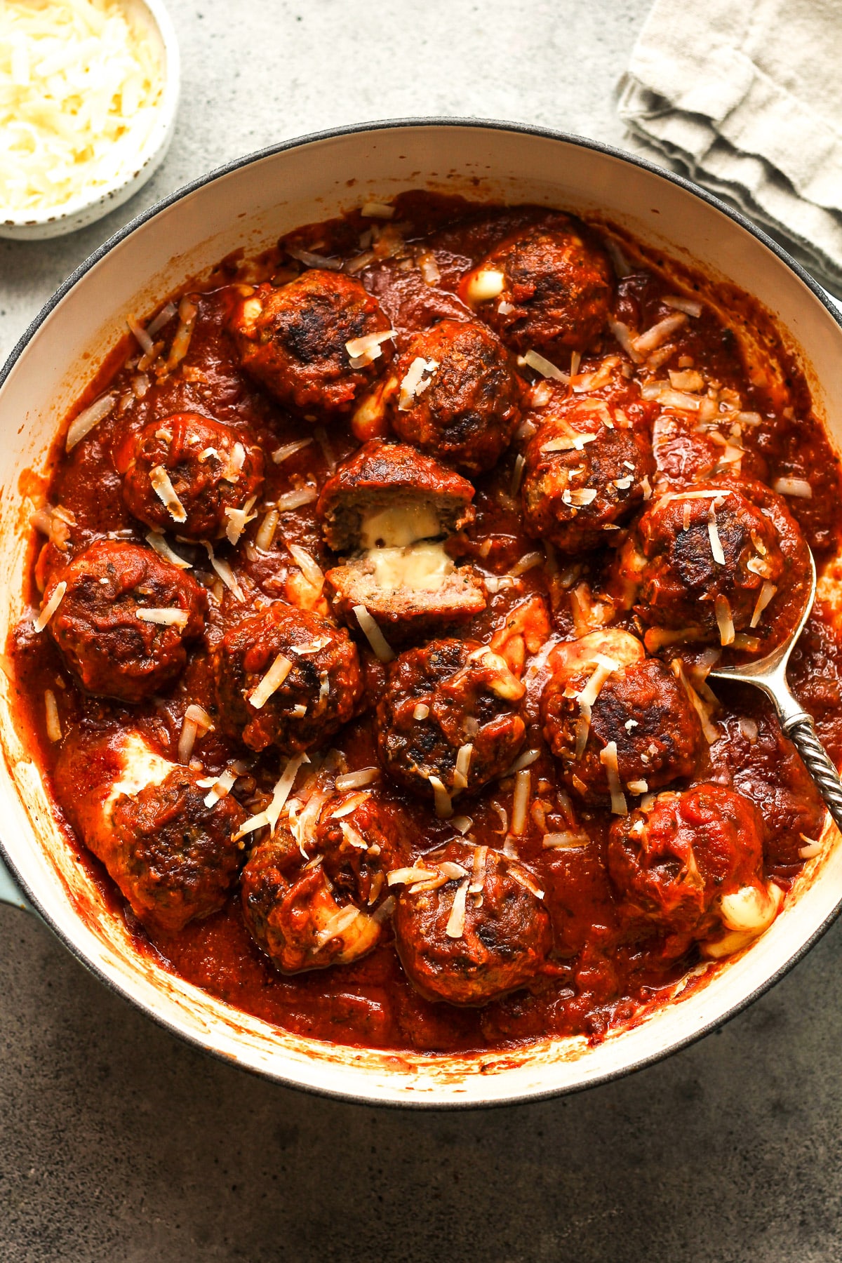 A braiser of simmered stuffed meatballs with sauce.