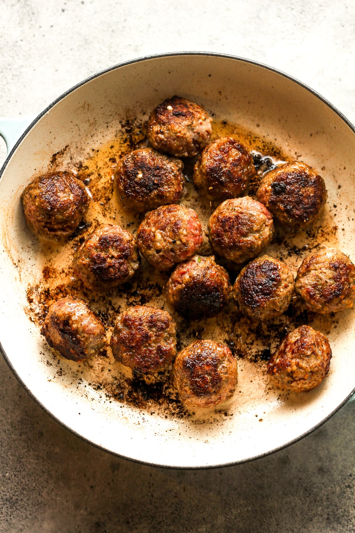 A pan of the sautéed meatballs.