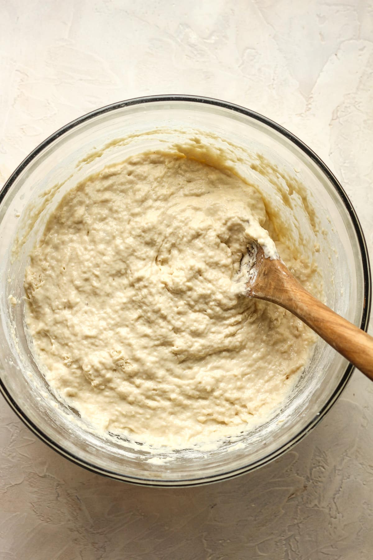 A large glass bowl of the finished dough.