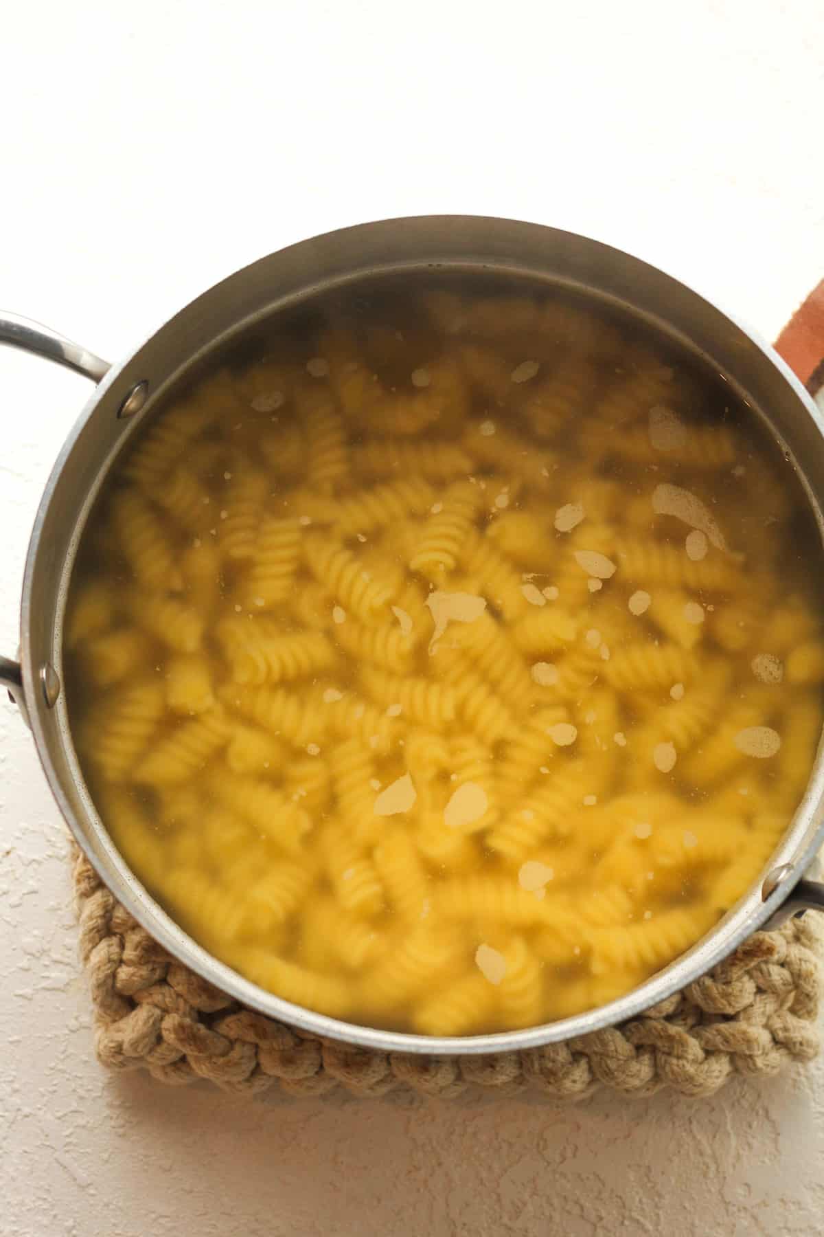 A pot of the cooked rotini pasta.