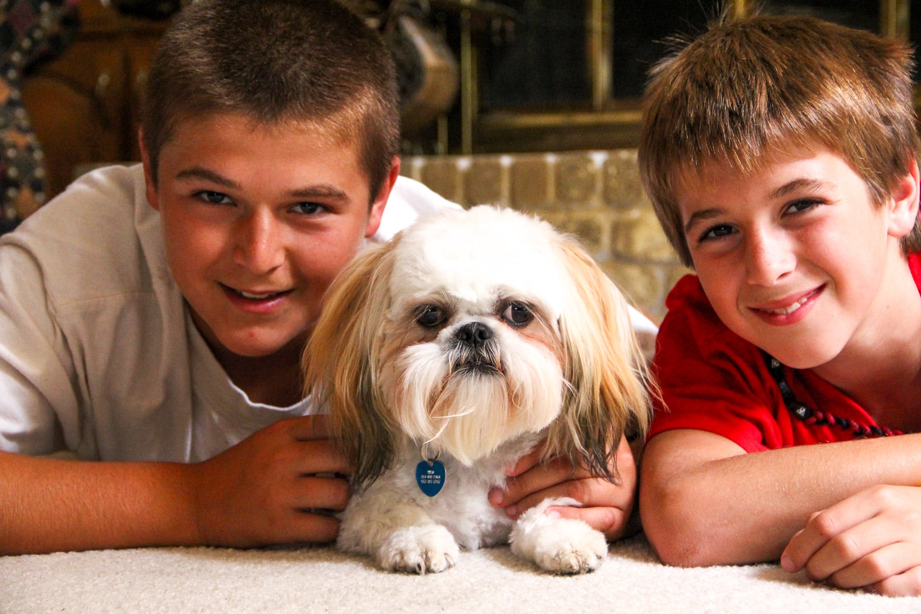 Our boys, Josh and Zach, with our pup Theo on the floor.