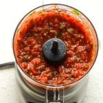 Closeup on a mini food processor full of salsa.