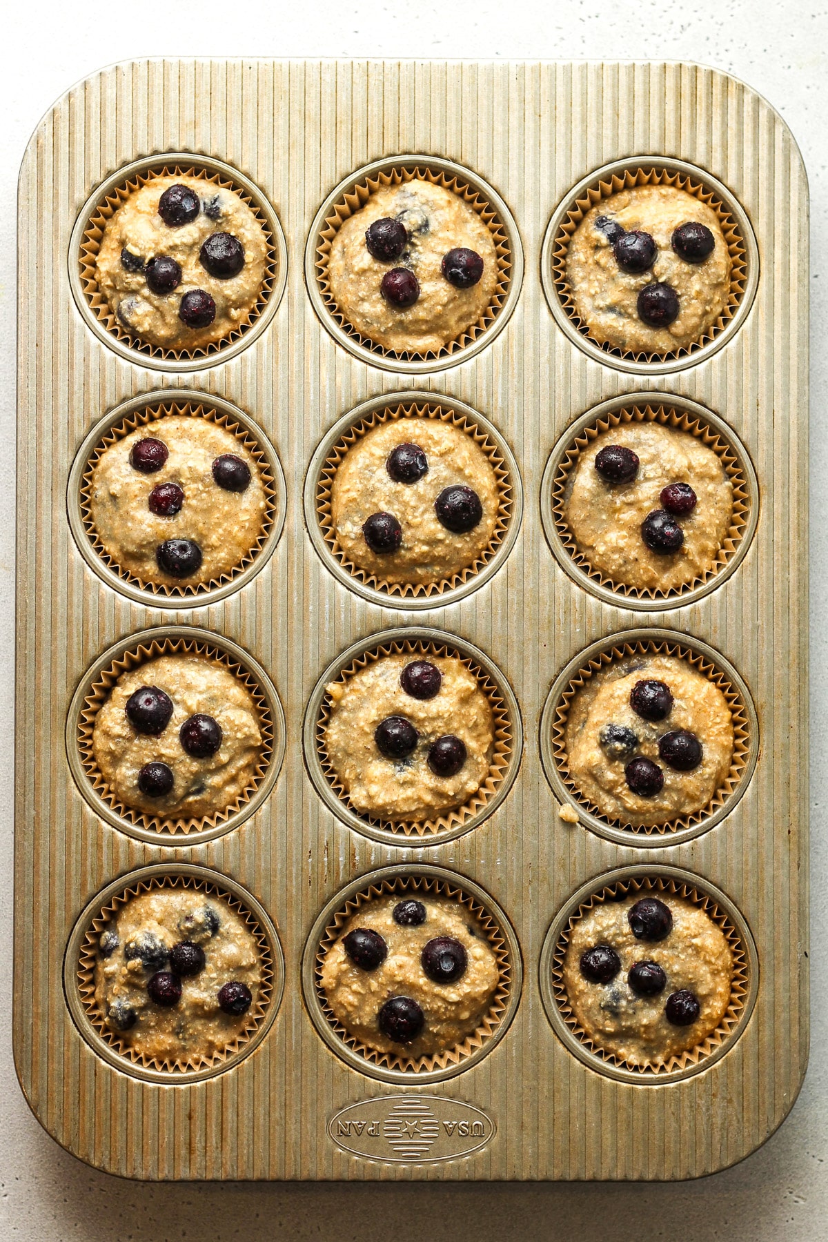 A muffin tin with the muffin batter.