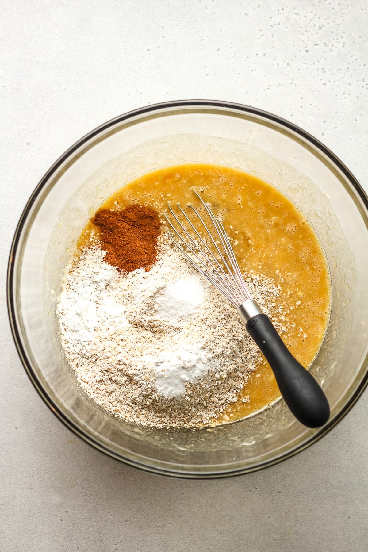 A bowl of the wet ingredients and dry on top.