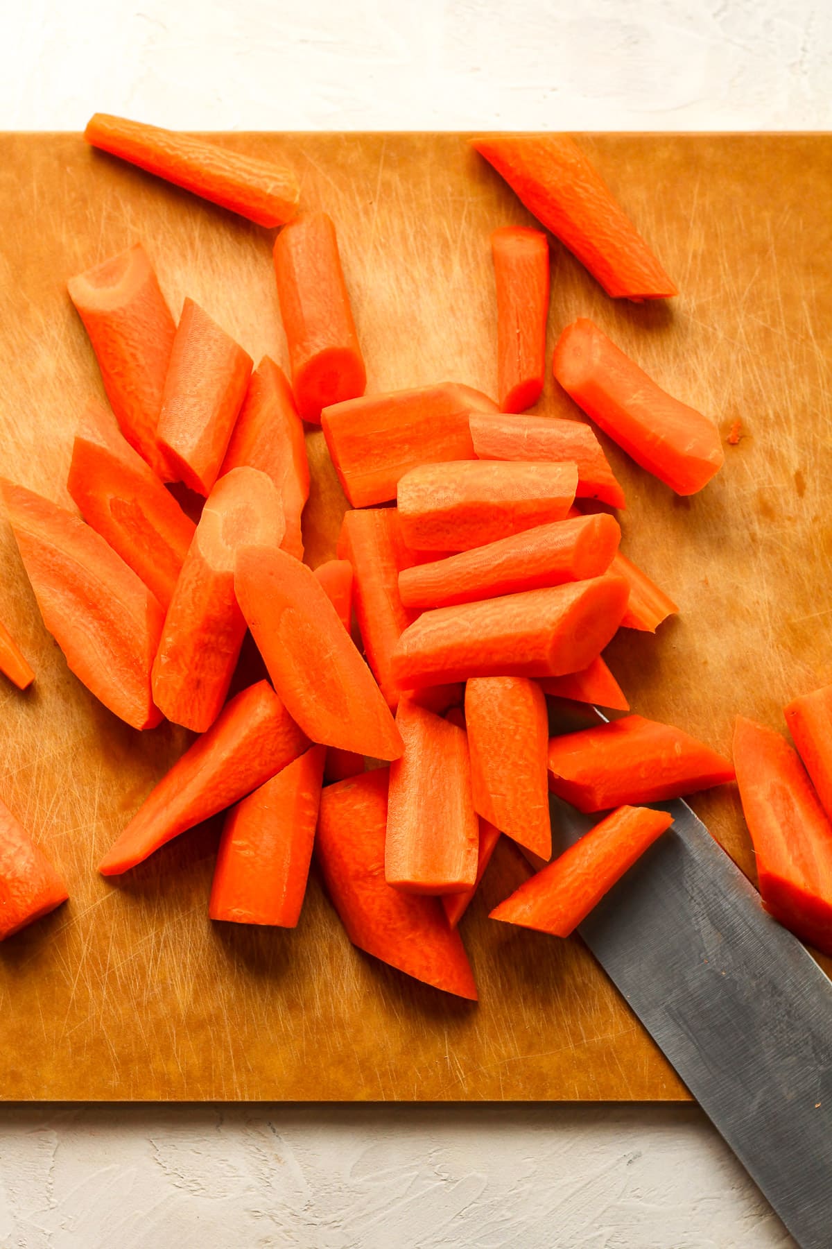 A cutting board with the carrots after prepping.