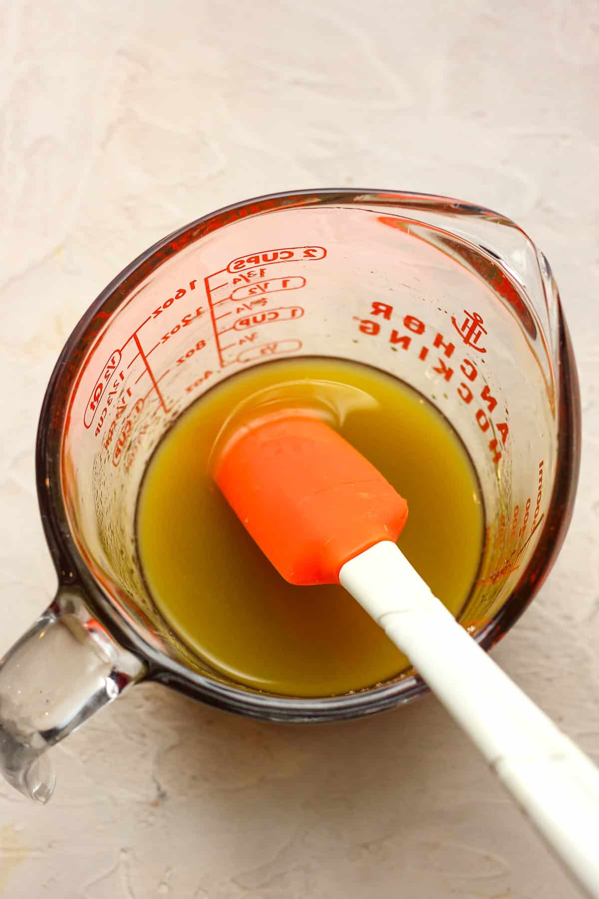 A measuring cup of the liquid mixture to add to the carrots.