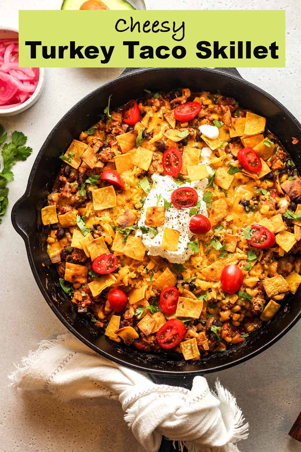 A cheesy turkey taco skillet with a dollop of sour cream.