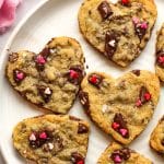 Closeup on a plate of heart-shaped chocolate chip cookies.