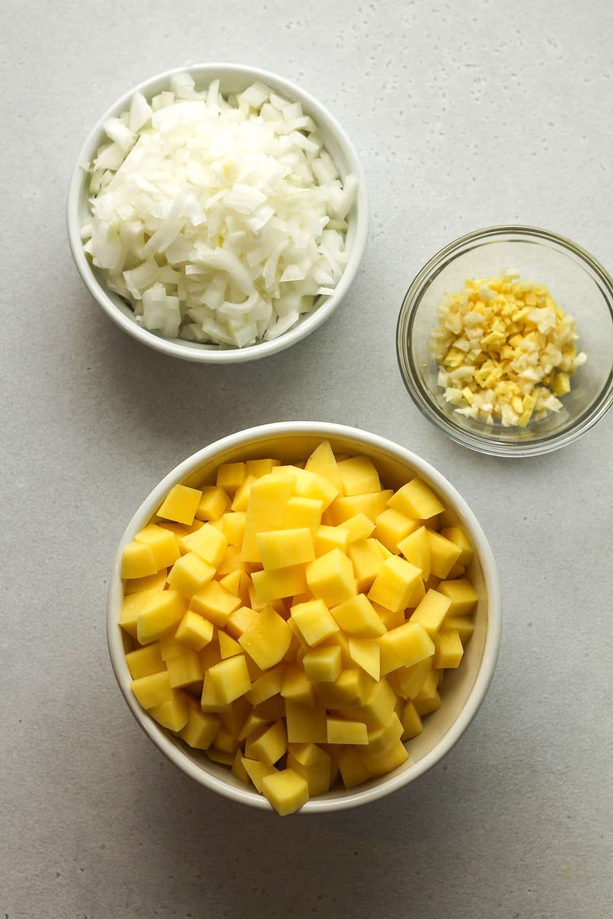 Three bowls of the chopped and minced veggies.