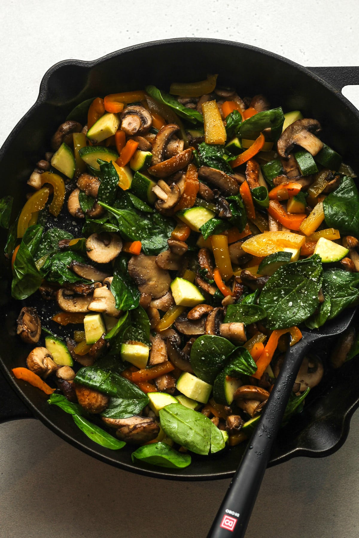 A large skillet of sautéed vegetables.